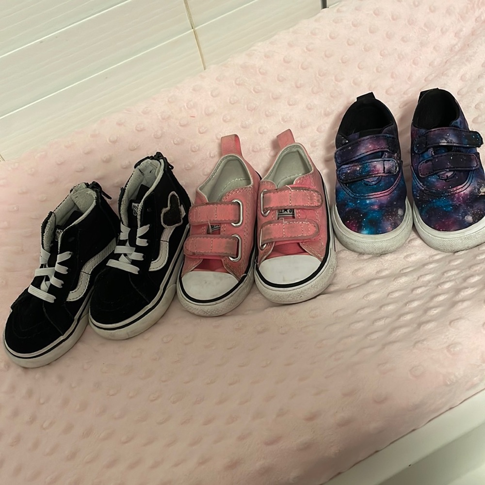 Three pairs of toddler girl shoes. Converse and Vans high top and low top